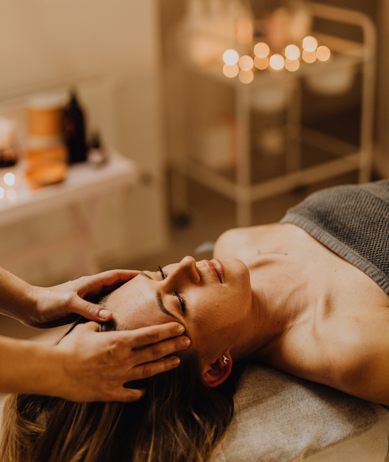 Woman having a massage session - Totality Healing